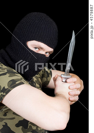 The criminal with a knife in a black mask The criminal with a knife in a black mask 4579887