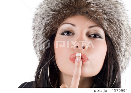 Portrait of the young woman with a finger at lips 4579994