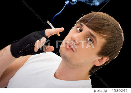Young  man with a cigarette. Isolated on black 4580242