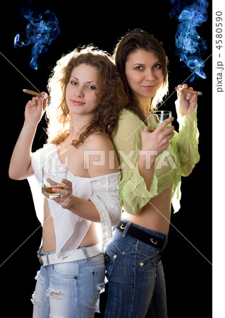 Two smiling pretty girlfriends with a cigars 4580590
