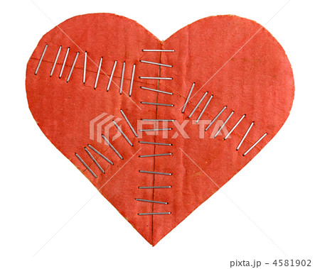 Broken cardboard heart with staples isolated on white background 4581902