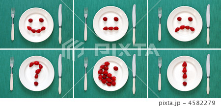 Food concepts - faces and symbols made of strawberries on plate 4582279
