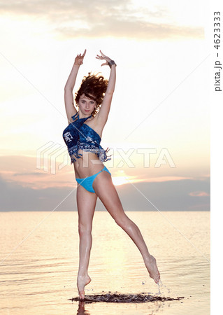 Sexy young woman jumping over the water 4623333