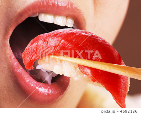 Beautiful young woman eating sushi Beautiful young woman eating sushi 4692136