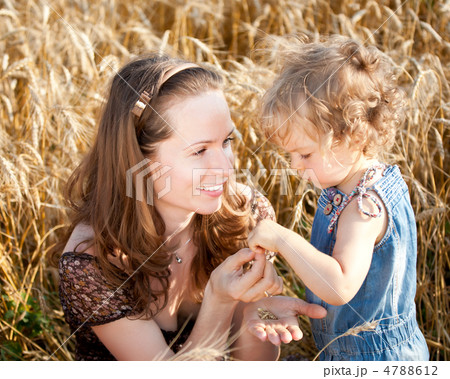 Woman and child in wheat field 4788612