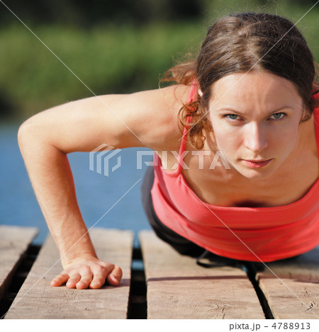 Woman doing push-ups Woman doing push-ups 4788913