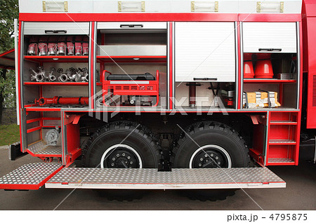 Open big red fire engine equipped with fire cocks and hoses at d 4795875