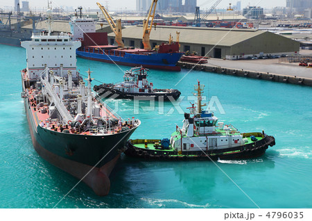 Two small boats docked to industrial ship in port at sunny day Two small boats docked to industrial ship in port at sunny day 4796035