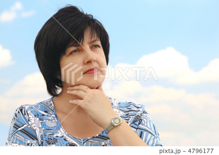 portrait of brunette plumpy mature serious woman, hand on chin, 4796177