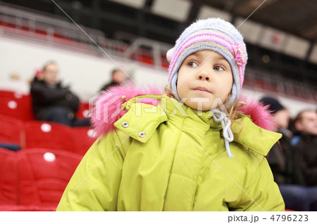 Girl looks after game of favourite hockey command with interest Girl looks after game of favourite hockey command with interest 4796223