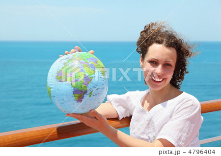 woman on deck of ship among sea with ball in form of globe 4796404