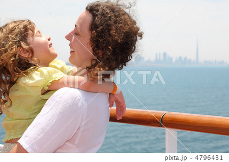 young mother carrying her daughter and laughing, standing on cru 4796431