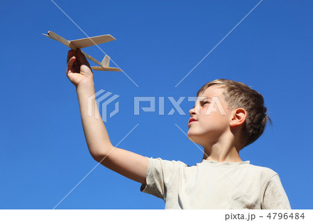 Boy in summer plays with  home-made model of airplane 4796484