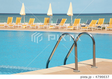 hotel swimming pool with stair, yellow longes and umbrellas hotel swimming pool with stair, yellow longes and umbrellas 4796637