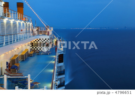 Illuminated cruise ship with people in the sea at night near cit Illuminated cruise ship with people in the sea at night near cit 4796651