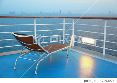 Illuminated solitary highlighted deck-chair on ship overlooking Illuminated solitary highlighted deck-chair on ship overlooking 4796657