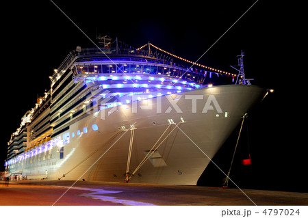 big modern cruise liner with blue lamps standing in dock at nigh big modern cruise liner with blue lamps standing in dock at nigh 4797024