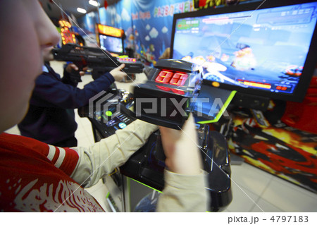 Hands of boys playing video games, they hold joystick in front o 4797183