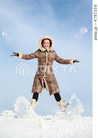 Girl jumps and throw snow hands and feet 4797359