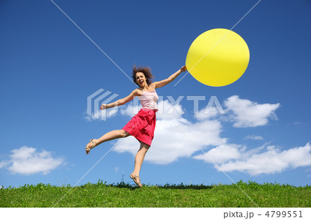 Woman barely touching earth flight away on balloon 4799551
