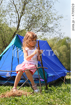 beautiful little girl in pink dress sitting near blue tent on na beautiful little girl in pink dress sitting near blue tent on na 4799929