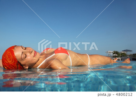 beautiful young woman in red swimsuit sunbathing in water in poo 4800212