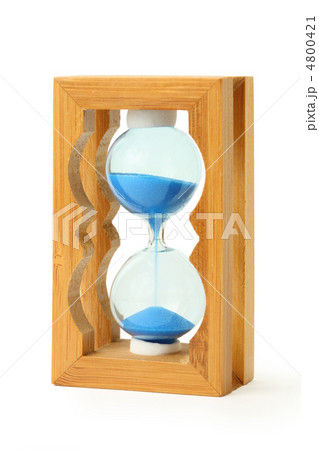 pure blue sand falls into wooden hourglass isolated on white pure blue sand falls into wooden hourglass isolated on white 4800421