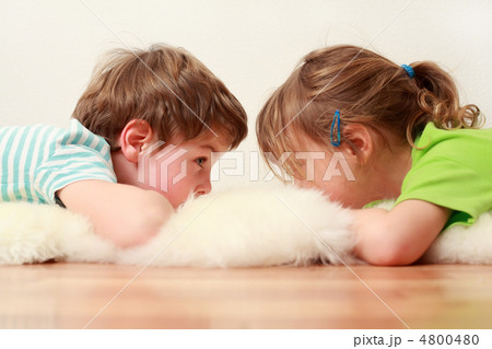 little brother and sister lying on floor on white skin and look little brother and sister lying on floor on white skin and look 4800480