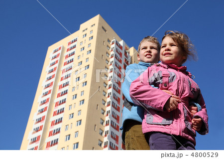 brother hugs little sister. girl in pink jacket, boy in blue jac brother hugs little sister. girl in pink jacket, boy in blue jac 4800529