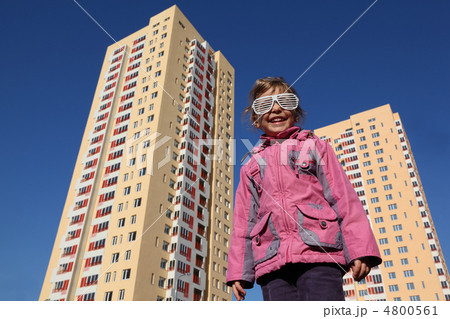 beautiful little girl in pink jacket and big white glasses, two 4800561