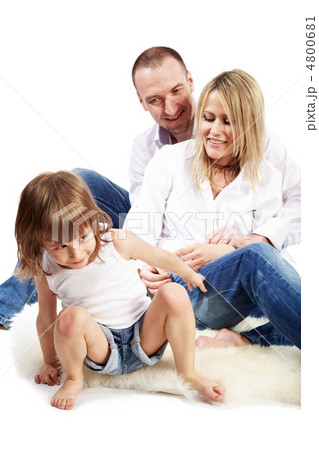 Father, mother and little daughter sit on the white hairy carpet Father, mother and little daughter sit on the white hairy carpet 4800681
