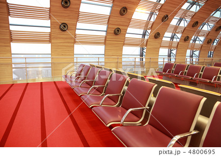 Empty waiting room at airport, red floor and armchair, big windo 4800695