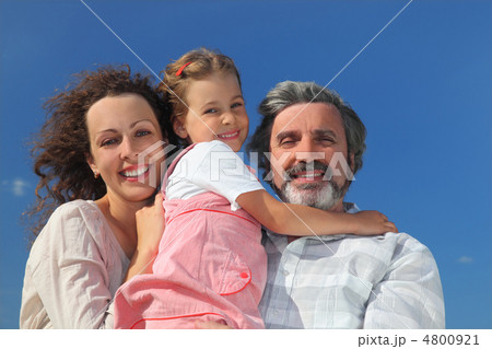 family with girl, mother and grandfather smiling and embracing, 4800921