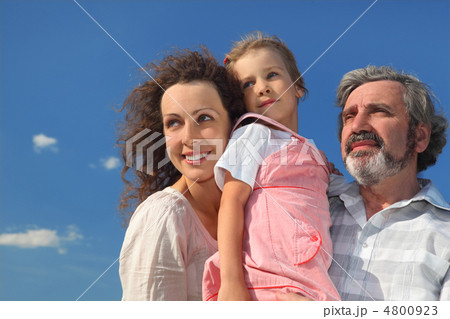 family with girl, mother and grandfather smiling and looking at 4800923