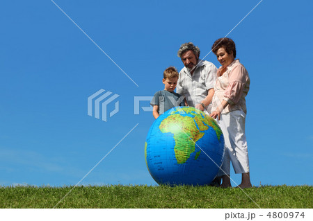 boy and his grandparents standing on lawn and looking on big inf 4800974