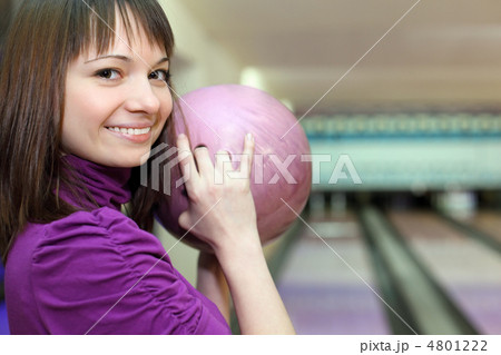 Girl stands sideways and smiles with ball in hands 4801222