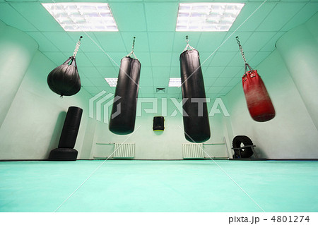 empty light green room, where black and red punching bag hang empty light green room, where black and red punching bag hang 4801274