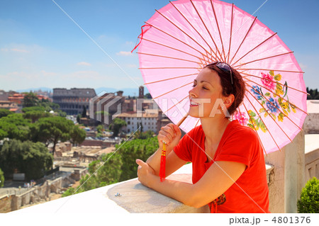 beautiful young woman with pink umbrella looks at Rome from Alta 4801376