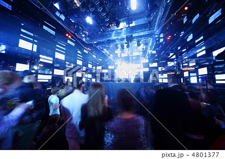 People dancing at concert in nightclub, light show and loud musi 4801377