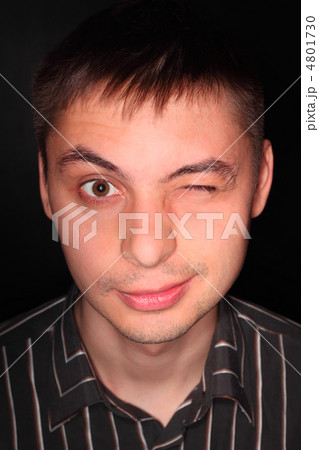 Handsome young man in striped black shirt portrait over black, m 4801730