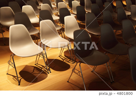 several rows of white plastic chairs with metal legs on yellow f several rows of white plastic chairs with metal legs on yellow f 4801800
