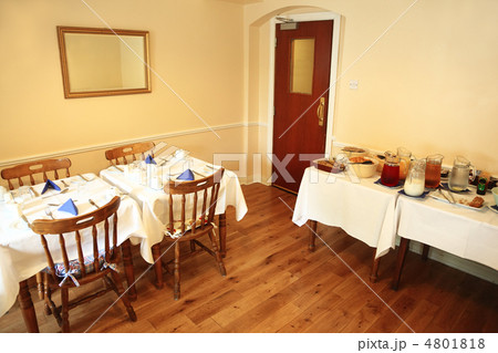 Small, cozy restaurant with food on table, buffet service 4801818