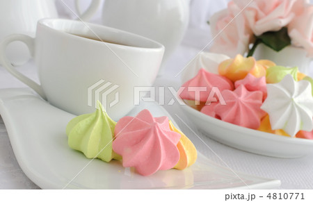 Meringue cookies on a plate with a cup of coffee 4810771