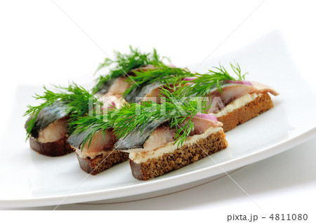 Sandwiches of rye bread with herring, onions and herbs. Sandwiches of rye bread with herring, onions and herbs. 4811080