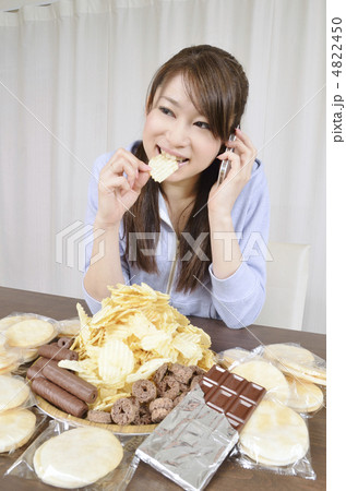 スナック菓子を食べながら電話をかける女性 4822450