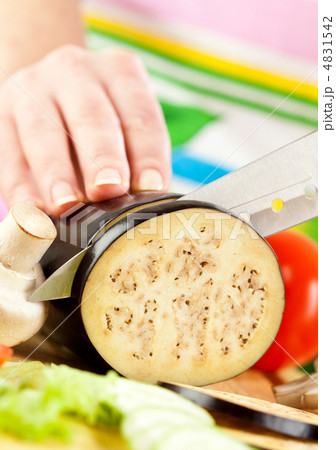 Woman's hands cutting aubergine eggplant Woman's hands cutting aubergine eggplant 4831542