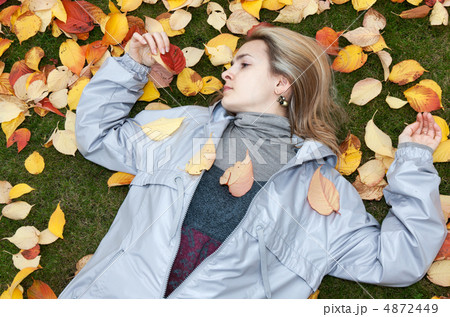 Beautiful girl rests upon autumn sheet 4872449