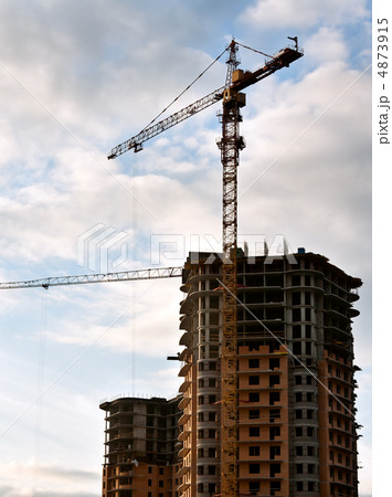Stand, house, construction crane in the sky with clouds 4873915