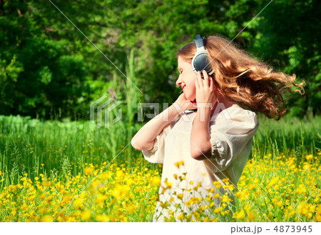 beautiful girl in headphones enjoying the music with flowing hai 4873945