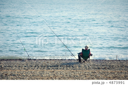 fisherman with a fishing rod fishing on the background of sea fisherman with a fishing rod fishing on the background of sea 4873991